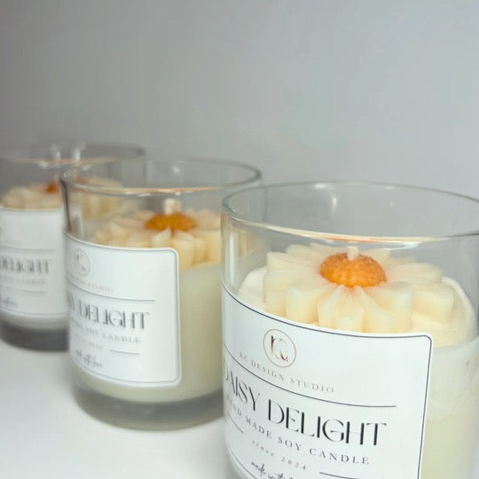 Side view of three 10oz Daisy Delight Candles, emphasizing their elegant vessels and the cheerful essence of daisies.