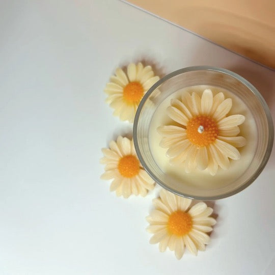 Top view of the 10oz Daisy Delight Candle featuring three wax daisies, showcasing the beautiful presentation and inviting scent.