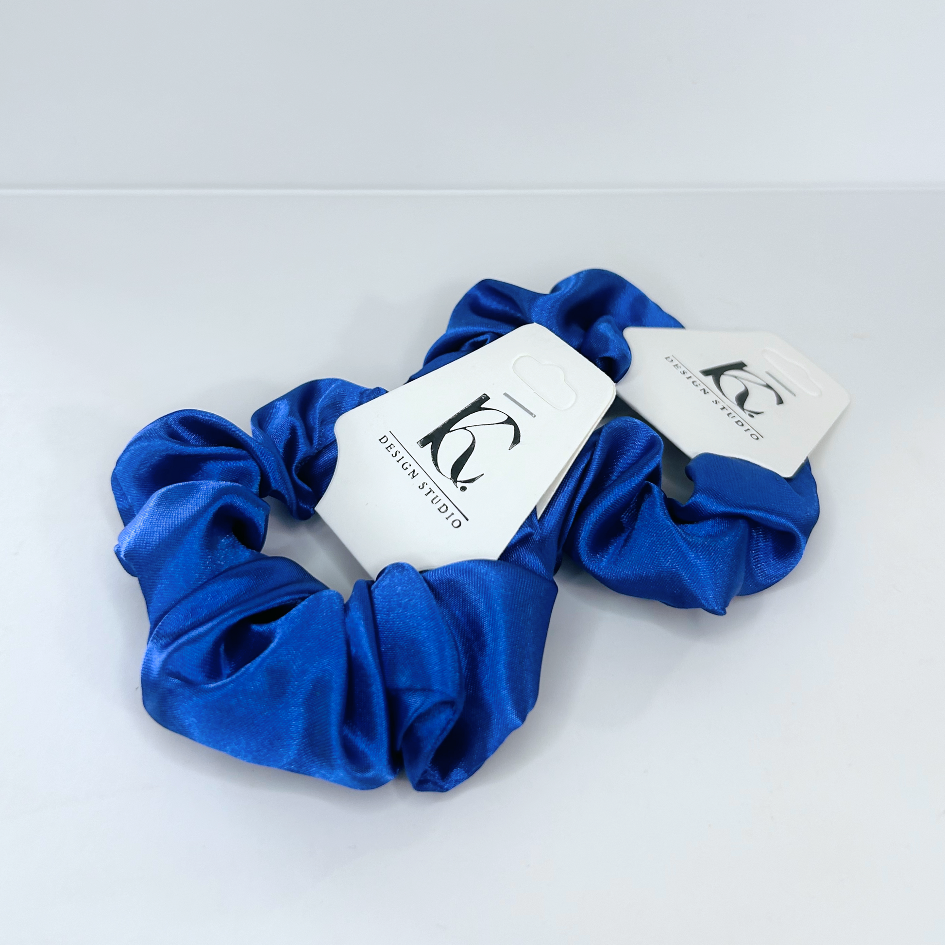 Rich dark blue silk scrunchie exuding sophistication and elegance.