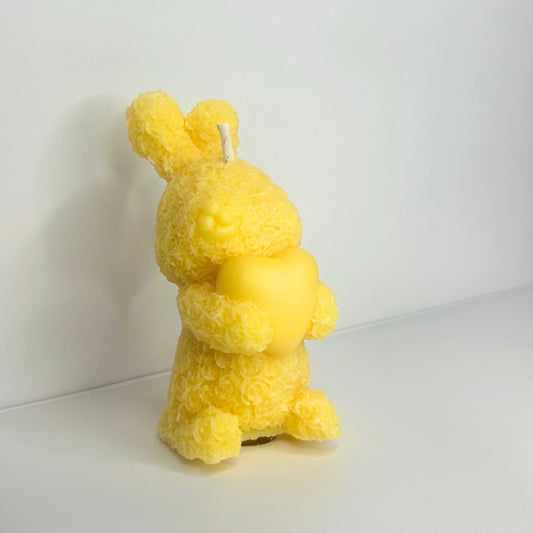 Front view of a Decorative Floral Bunny Candle, showcasing its whimsical design and vibrant yellow color.