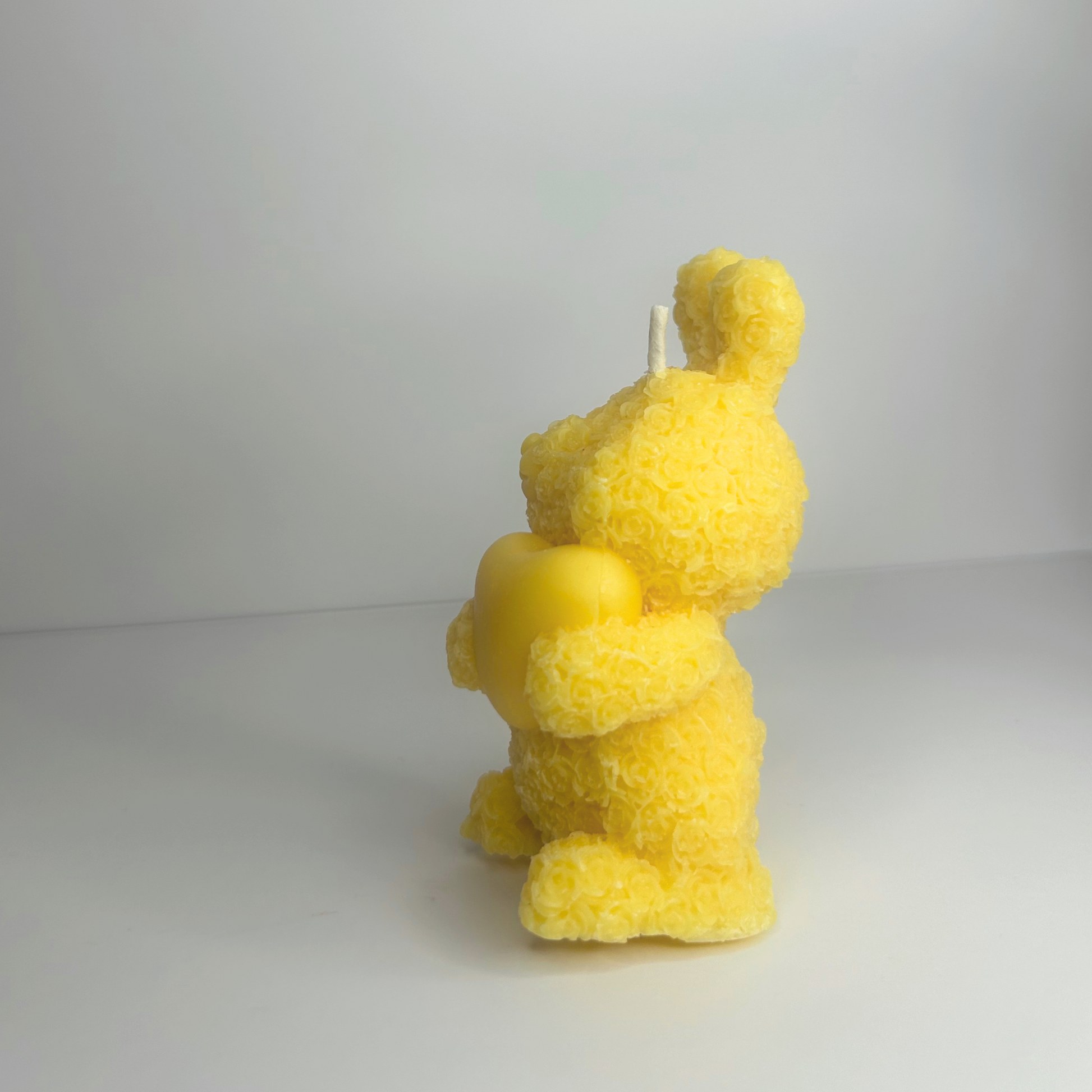 Side view of the Decorative Floral Bunny Candle, highlighting its charming yellow shape and floral details.