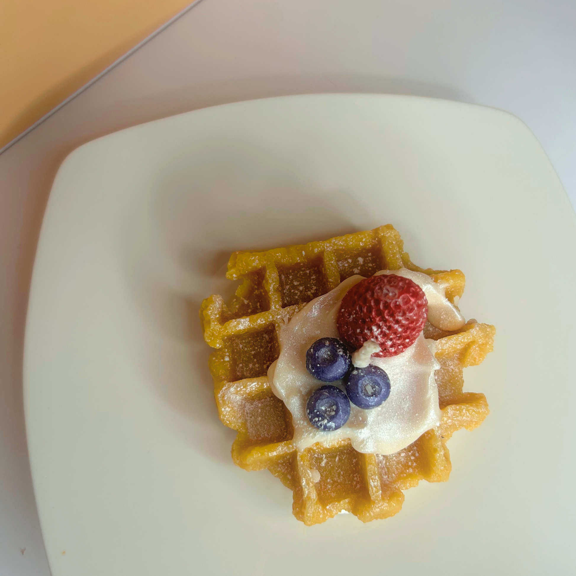 Top view of decorative French Waffle Scented Candle showcasing its delightful waffle design and vibrant colors.