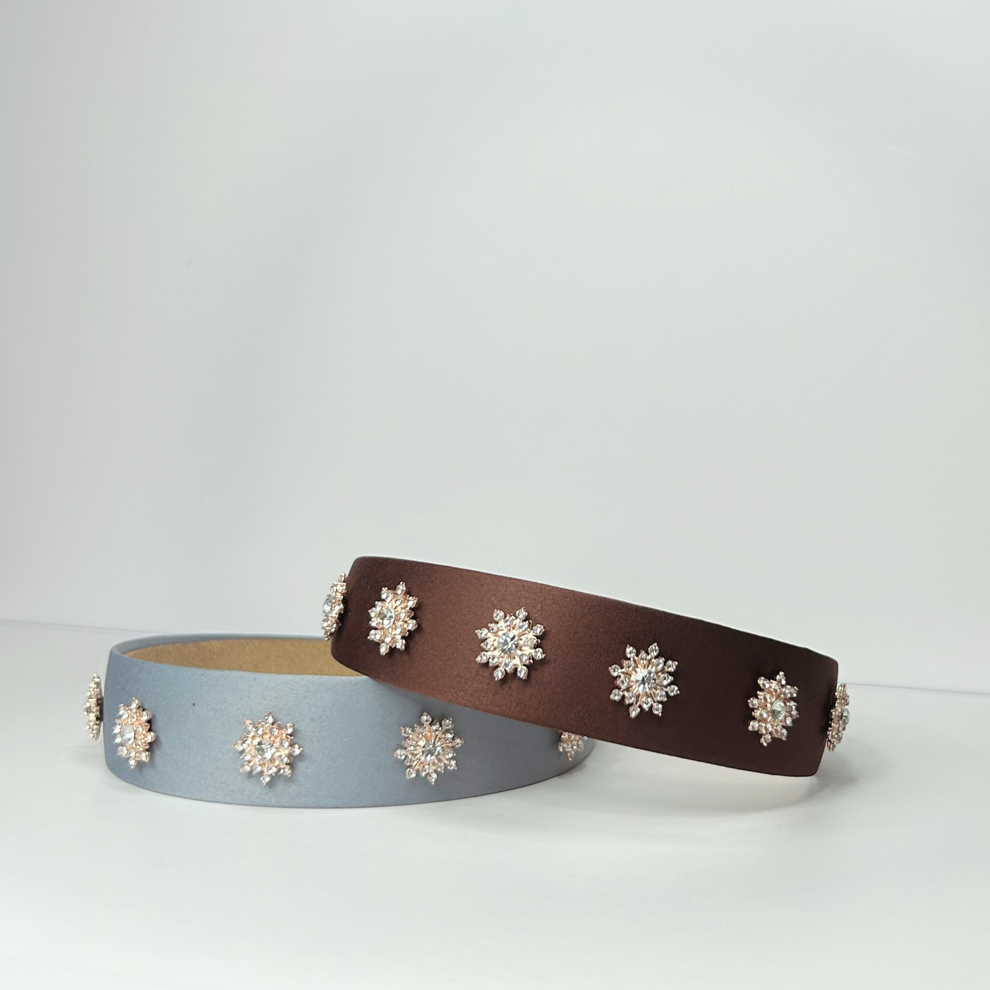 Front view of brown and baby blue alloy headbands stacked, durable and stylish handcrafted accessories for all-day comfort.