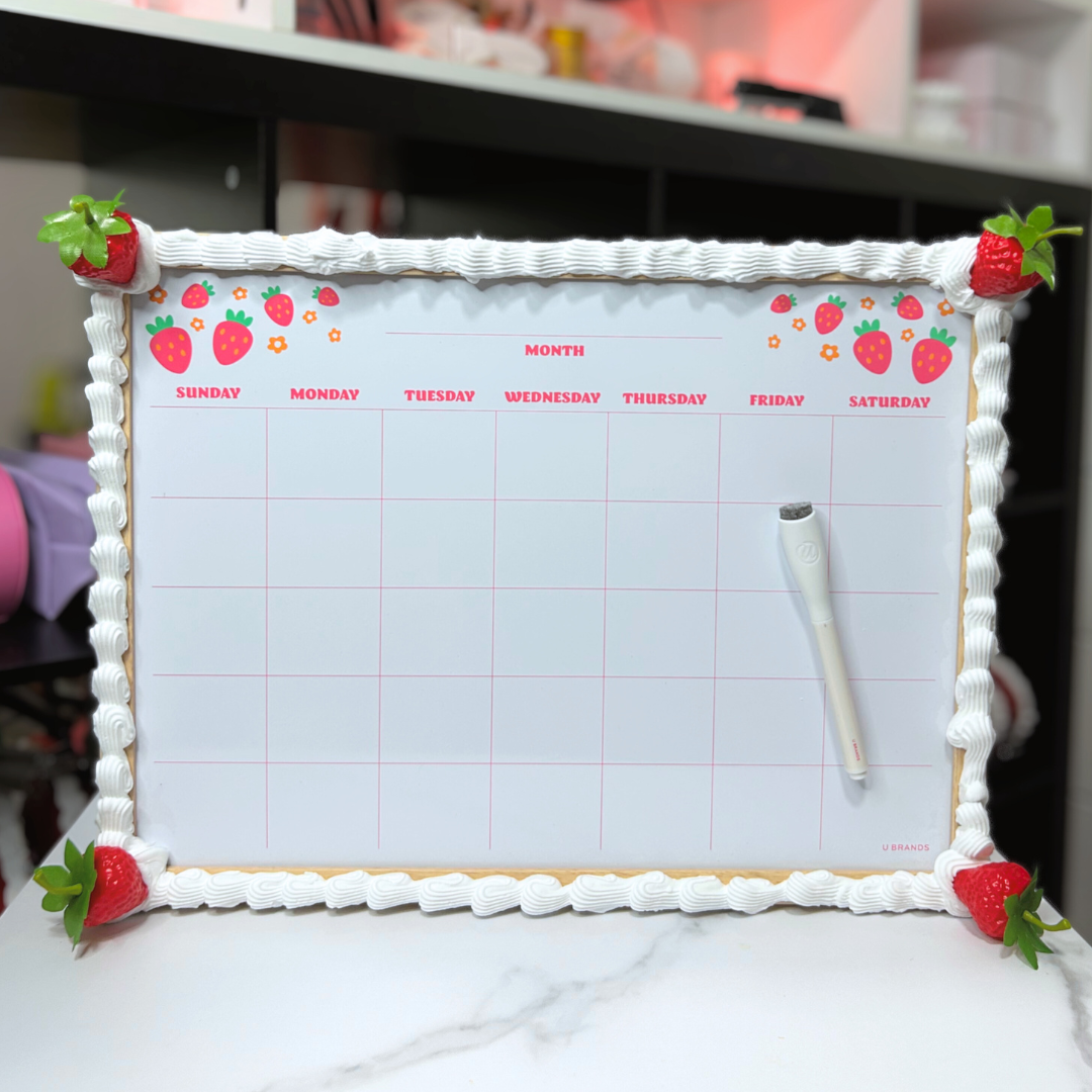 Calendar with strawberry decorations on a white surface