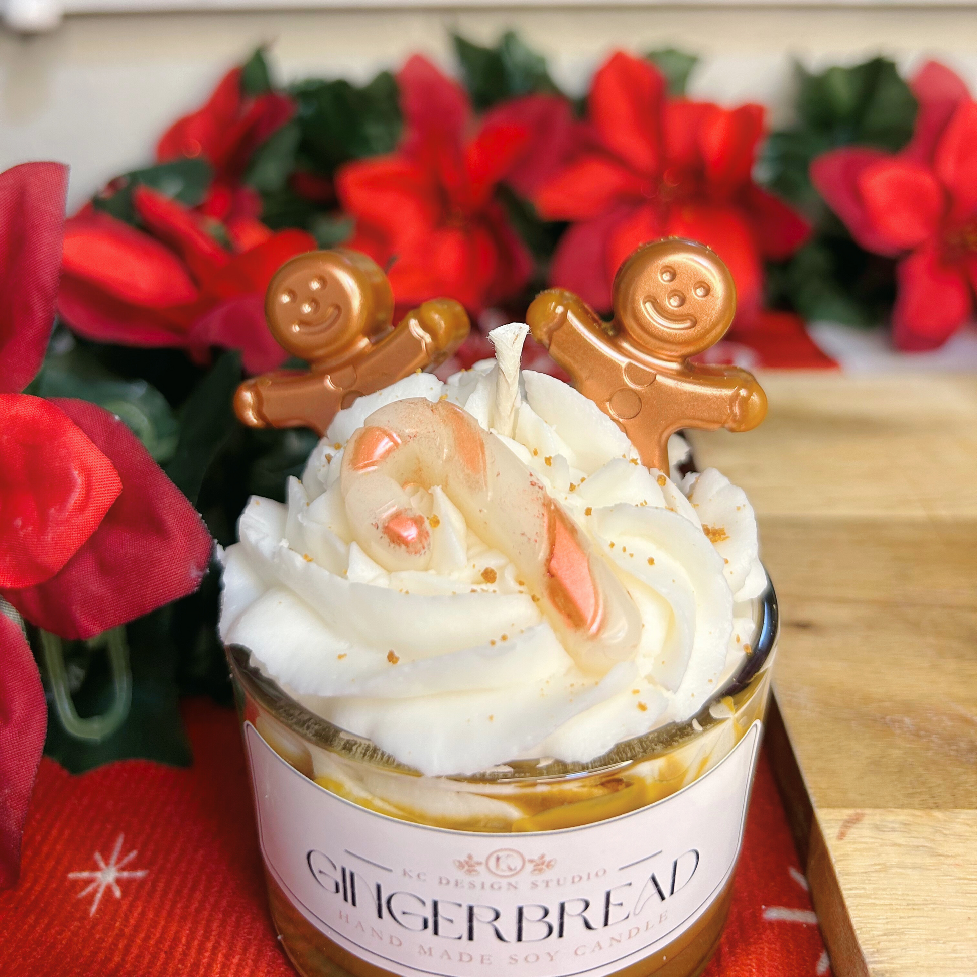 Top view of Christmas gingerbread candle with gingerbread men, candy cane decoration, and salted caramel sprinkles.