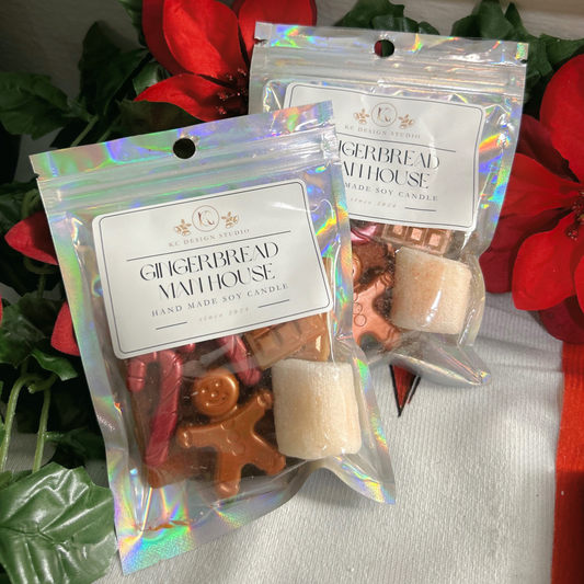 Front view of the Gingerbread Man House Wax Melts featuring a gingerbread man, cracker, candy canes, marshmallow, and chocolate bars in festive holiday colors.