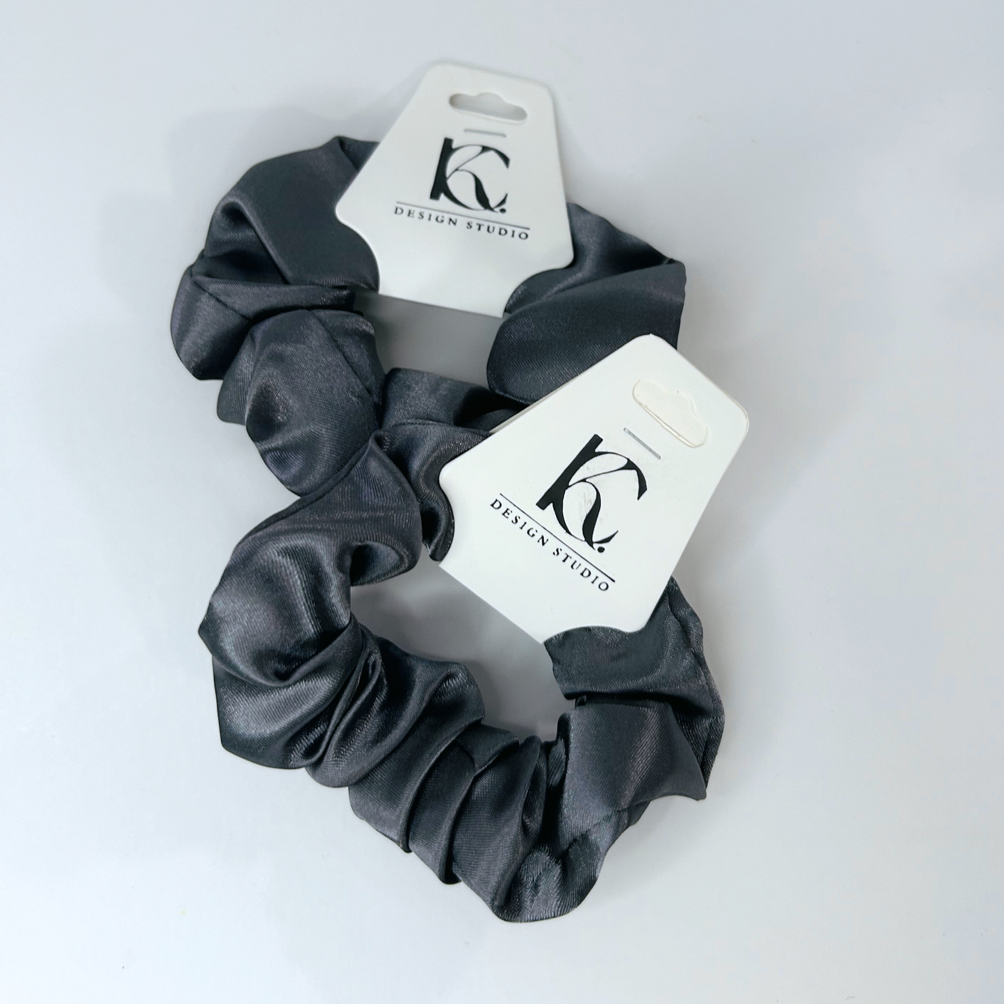 Chic gray silk scrunchie perfect for a minimalist aesthetic.