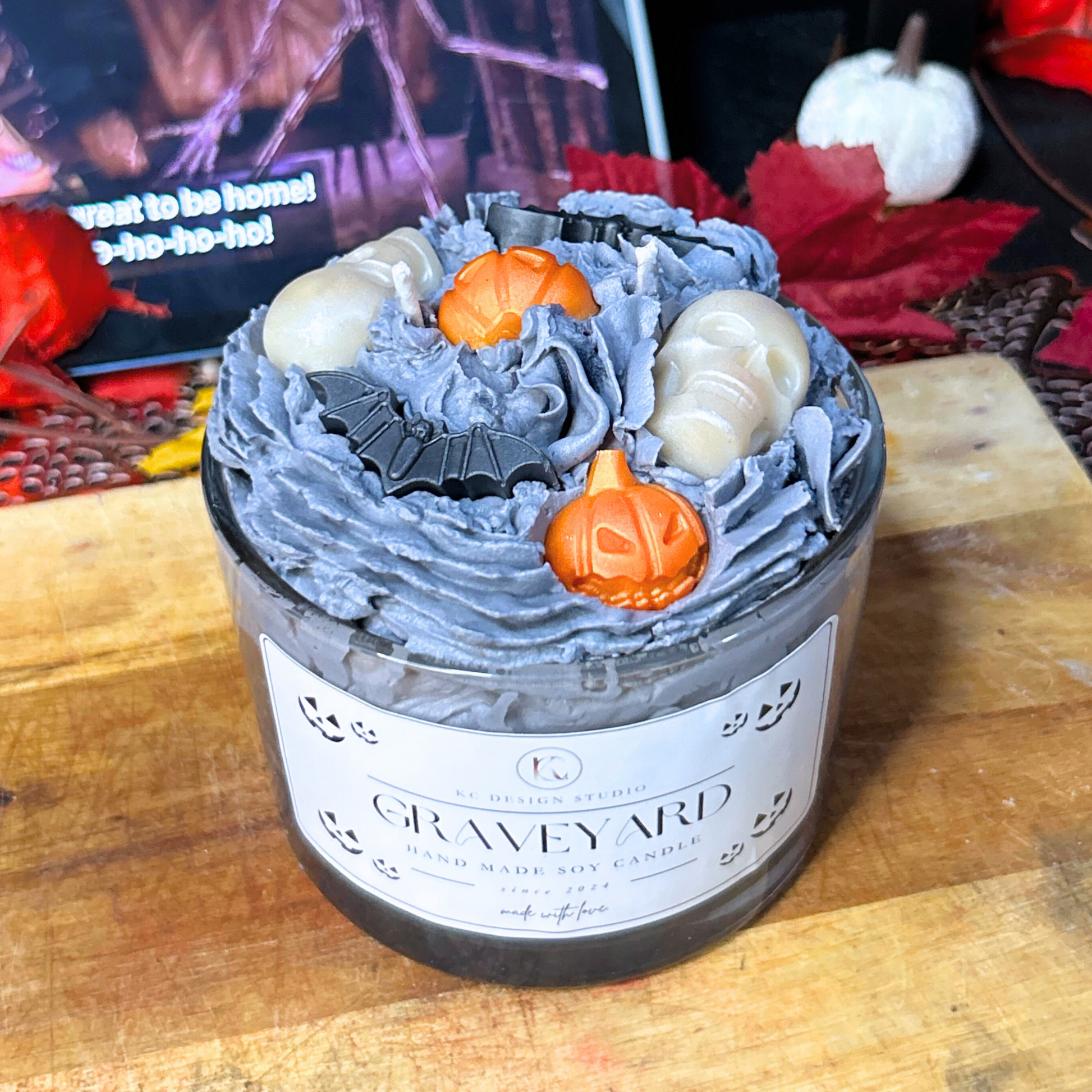 Angled view of Nightmare Before Christmas-inspired Halloween Graveyard Candle with layered witches brew, vanilla crumb, and whipped cream scents.