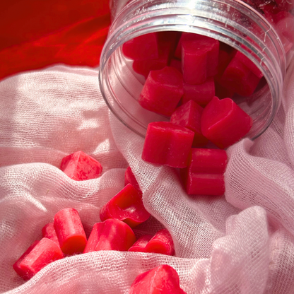 Close-up view inside the jar of Heart of Citrus wax melts, showcasing the smooth texture and adorable mini heart shape with a pink grapefruit aroma.
