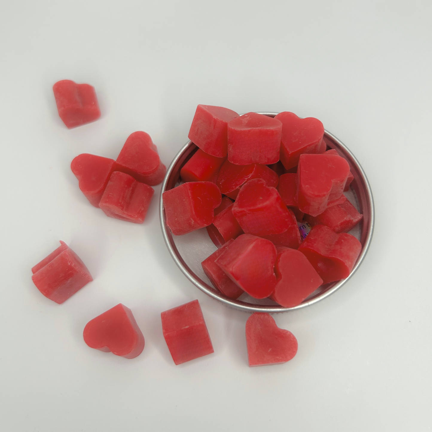 Close-up view of Heart of Citrus Wax Melts showcasing the vibrant red color and heart shapes.