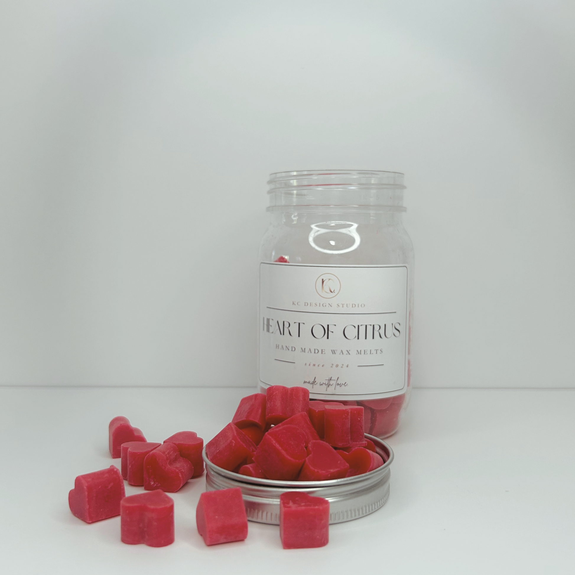 Front view of Heart of Citrus Wax Melts jar, featuring the label and colorful wax hearts