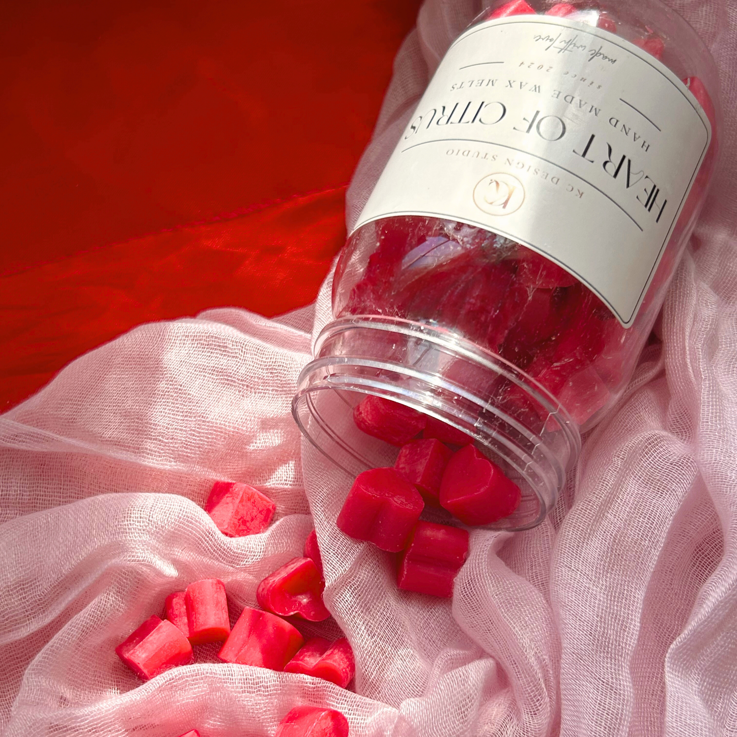 Top view of Heart of Citrus wax melts in a jar, featuring mini heart-shaped melts with a refreshing pink grapefruit scent, perfect for home fragrance.