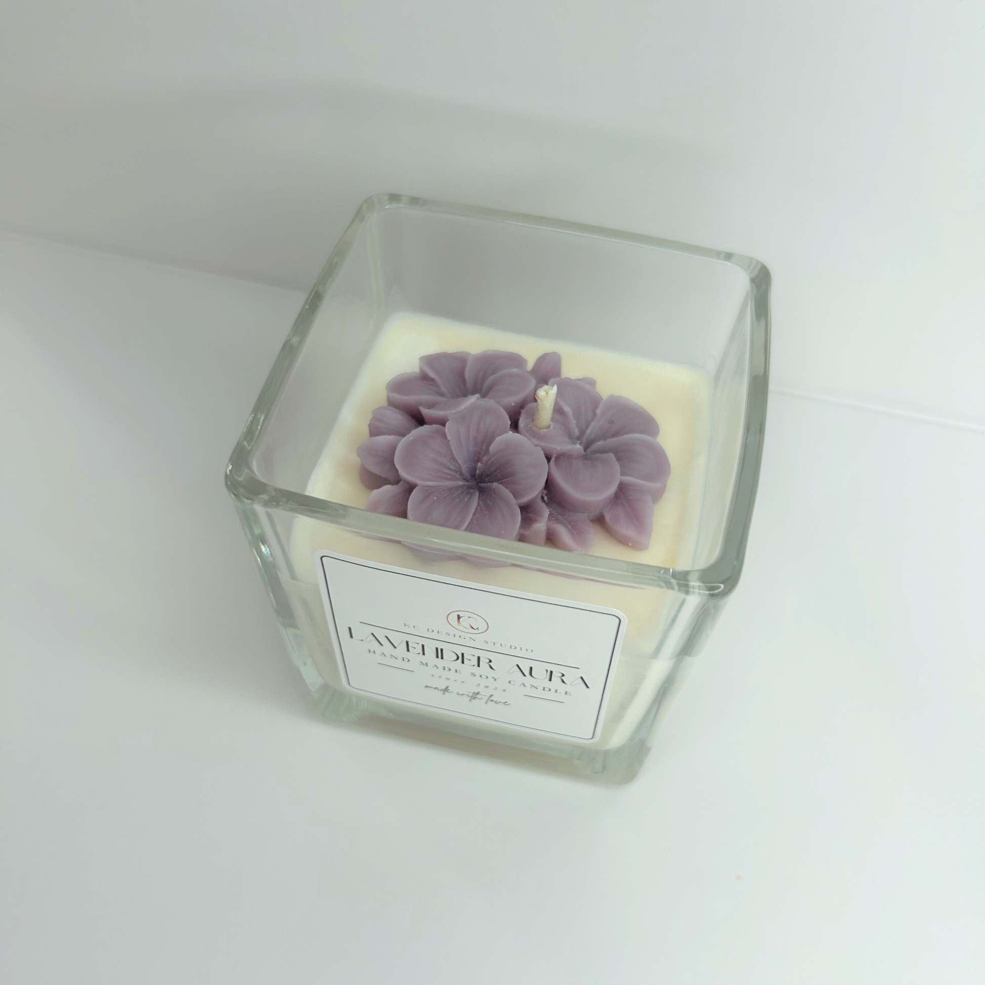 Top view of the 10oz Lavender Aura Candle without a lid, featuring the soft purple wax flowers and the smooth surface of the soy wax.