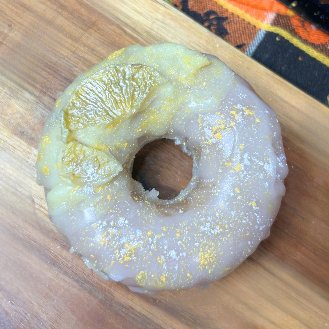 Single Lemon Drop donut wax melt with white and yellow icing, a lemon topper, and yellow and white mica powder details.