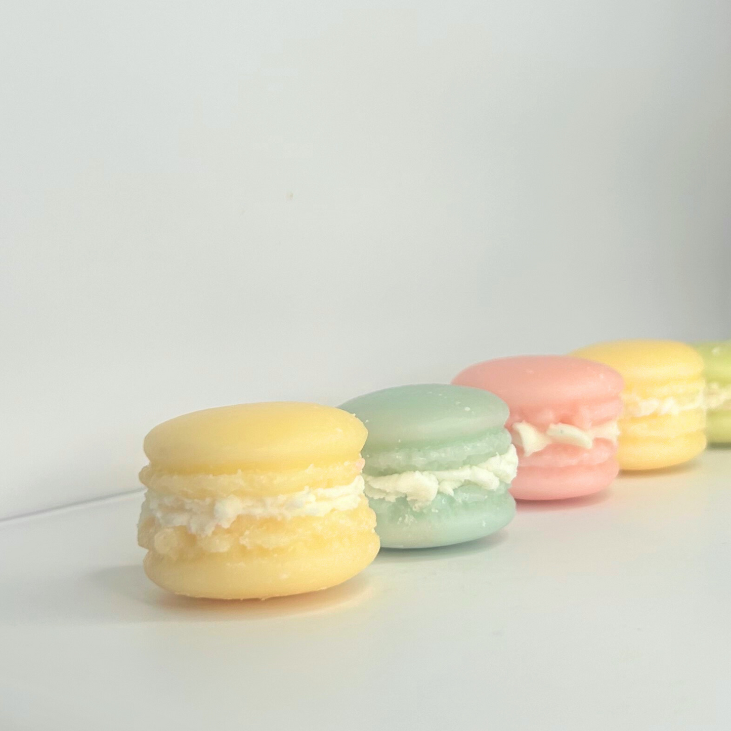 Side view of all Macaroon wax melts lined up, displaying their vibrant colors and sweetness.