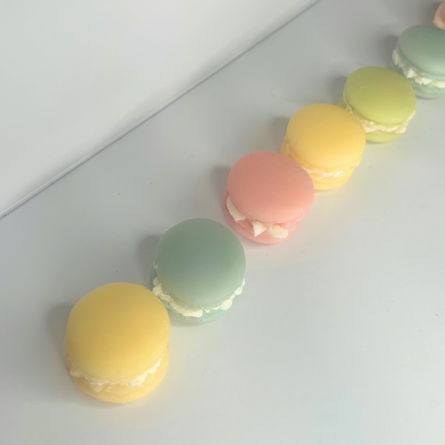 Top view of all Macaroon wax melts lined up, highlighting their sweet shapes and colors.