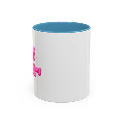 White mug with blue interior and pink text on a white background