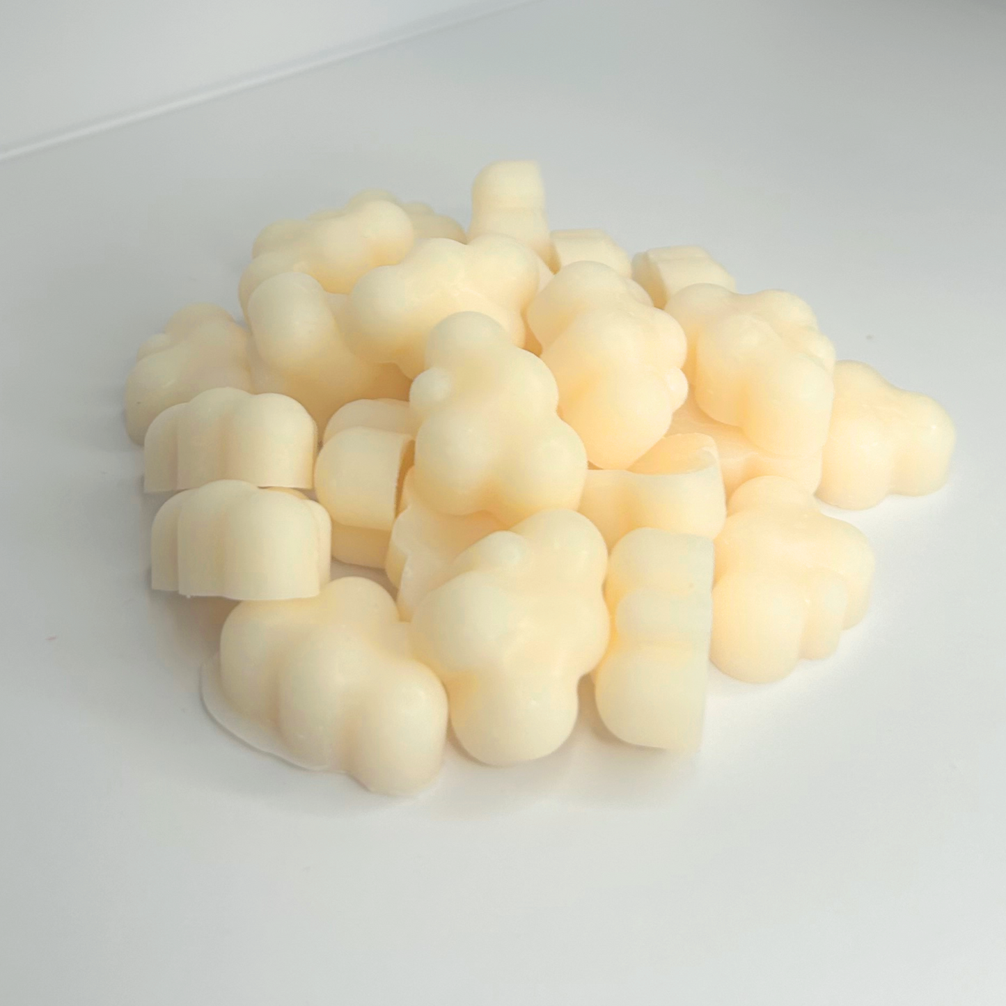 Close-up of Marshmallow Cloud wax melts outside the jar, showcasing their fluffy texture and details.