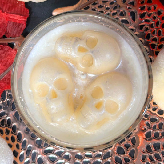 Top view of the Melting Souls Halloween candle featuring three melting skulls, inspired by gothic décor and the Corpse Bride aesthetic.