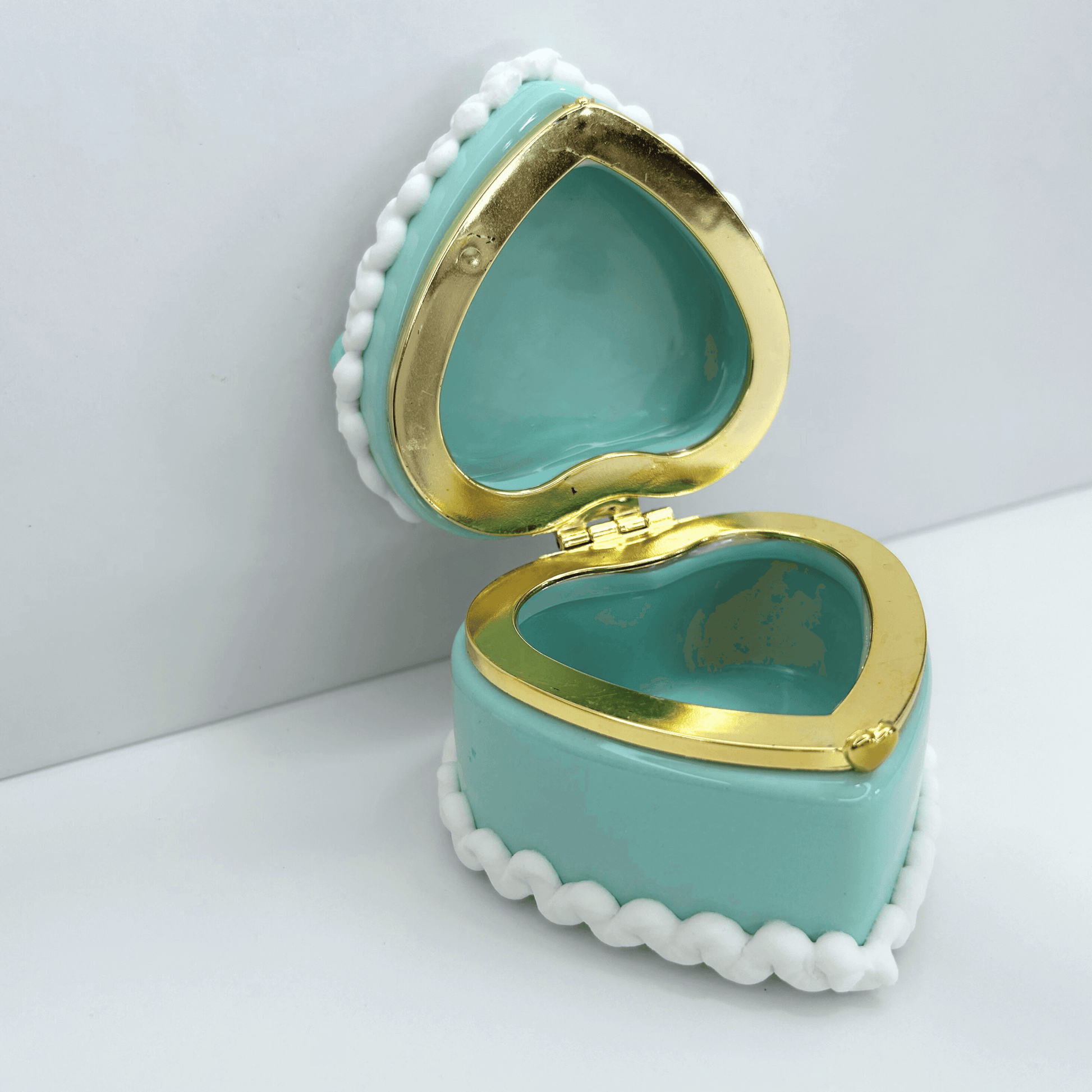 Open view of mini blue kawaii heart-shaped jewelry box showcasing interior storage space and charming details.