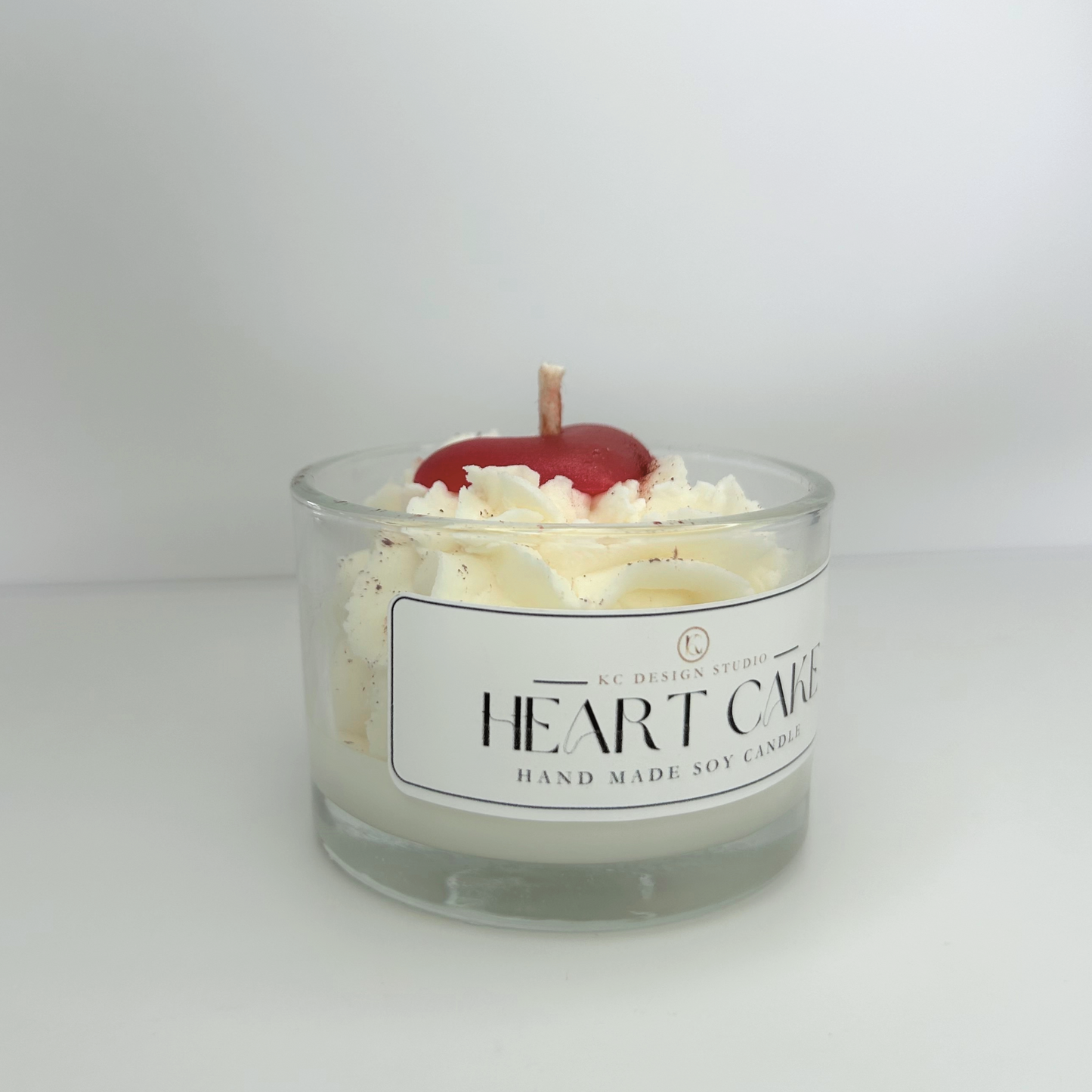 Side view of the Heart Cake Candle, emphasizing its petite size and eco-friendly cotton wick.