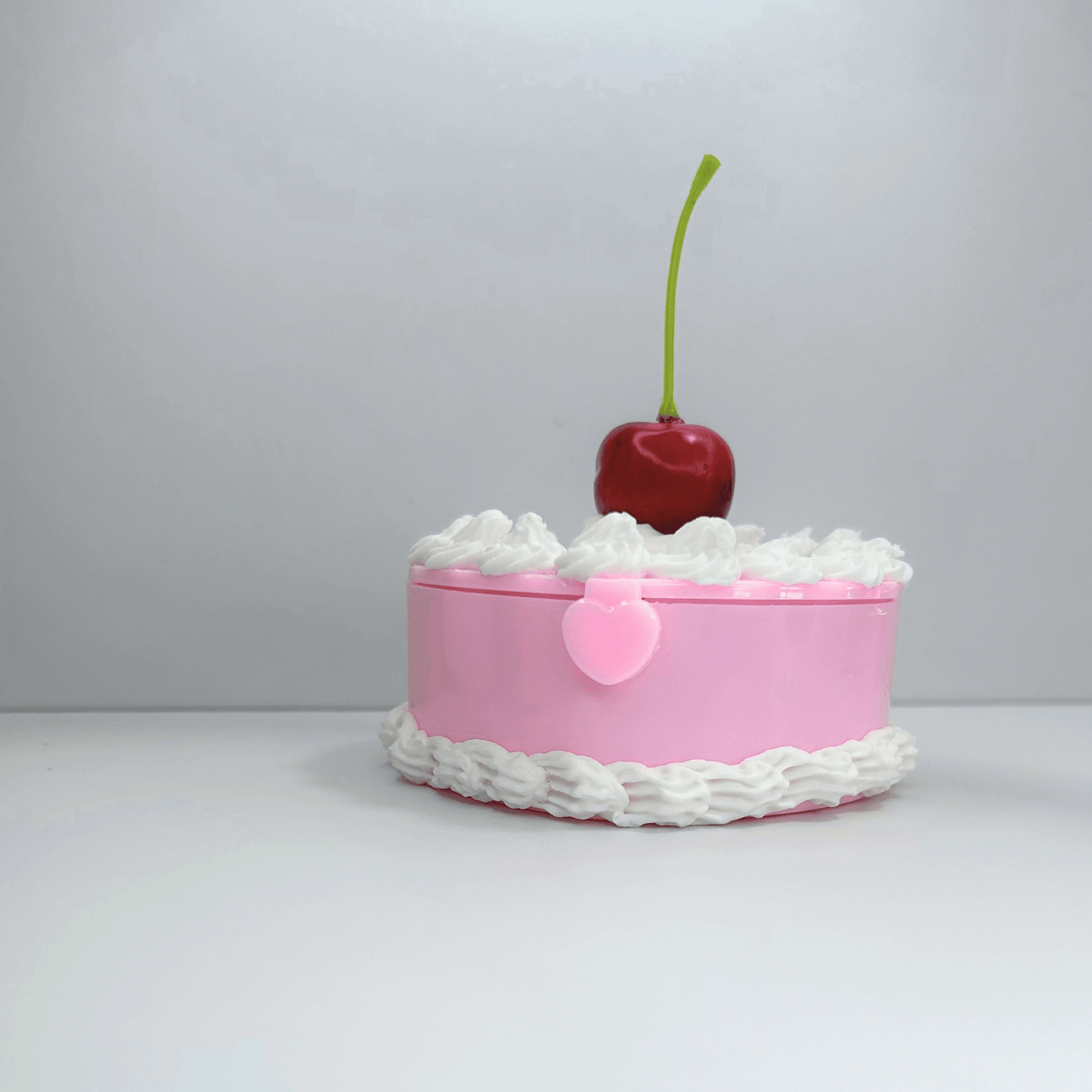 Front View of Mini Pink Cake Jewelry Box with Cherry and Cream Swirls.