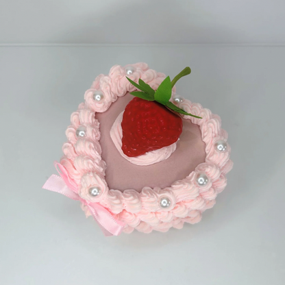 Top view of the Mini Strawberry Cake Jewelry Box, showcasing its adorable cake-like design with a pink bow, glossy pearls, and a sweet strawberry centerpiece.