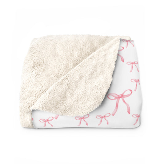 Blanket with pink bow pattern on a white background