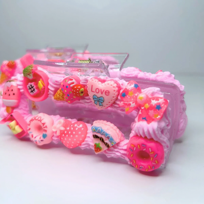 Close-up of pink creamy hair claw with detailed geometric design and cute charms.