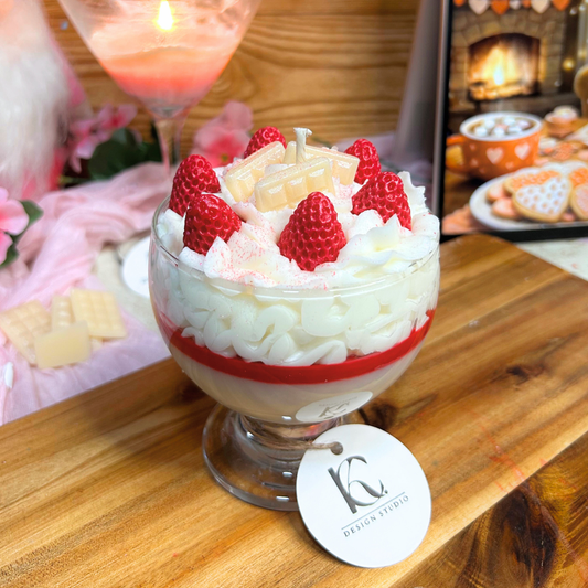 Red Velvet Berry dessert-style candle with whipped cream, strawberries, and white chocolate details on a cozy pink Valentine’s background