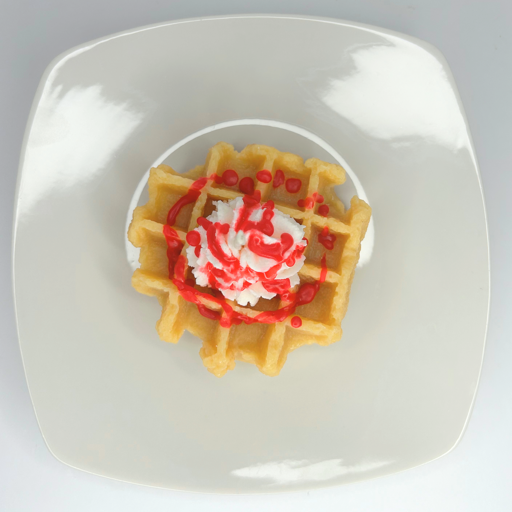 Top view of decorative Red Velvet Waffle Candle showcasing its rich colors and unique design.