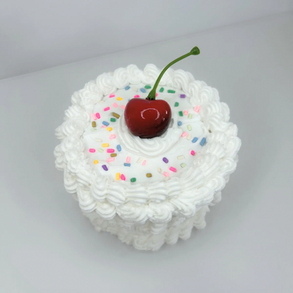 Top view of the Round Mini Cake Jewelry Box, showcasing its adorable cake-like design with a smooth finish and a sweet red cherry on top.