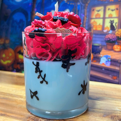 Back view of Sally’s Patch Candle showing the light blue wax base and hand-drawn stitched details surrounding the glass.