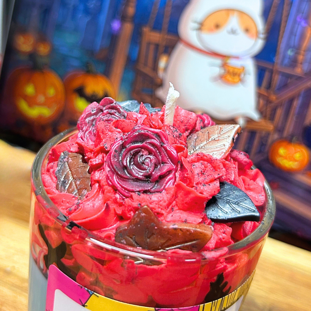 Top view of Sally’s Patch Candle showing the red whipped wax, decorative leaves, and roses finished with black mica powder.