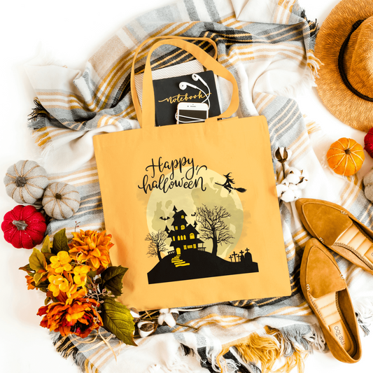 Orange Spooky Haunted House Tote showcasing a haunted house silhouette and 'Happy Halloween' text. Ideal for Halloween parties and everyday use.