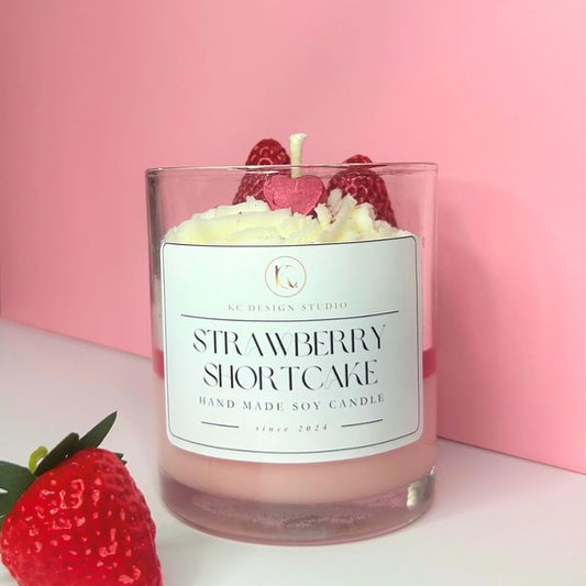 Front view of Strawberry Shortcake Candle with layers of strawberry, caramel crumbs, and vanilla whipped cream, topped with strawberries and a mini heart.