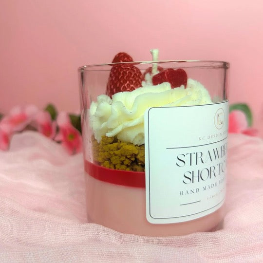 Side view of Strawberry Shortcake Candle highlighting the layered design with strawberry, caramel crumbs, and vanilla whipped cream.