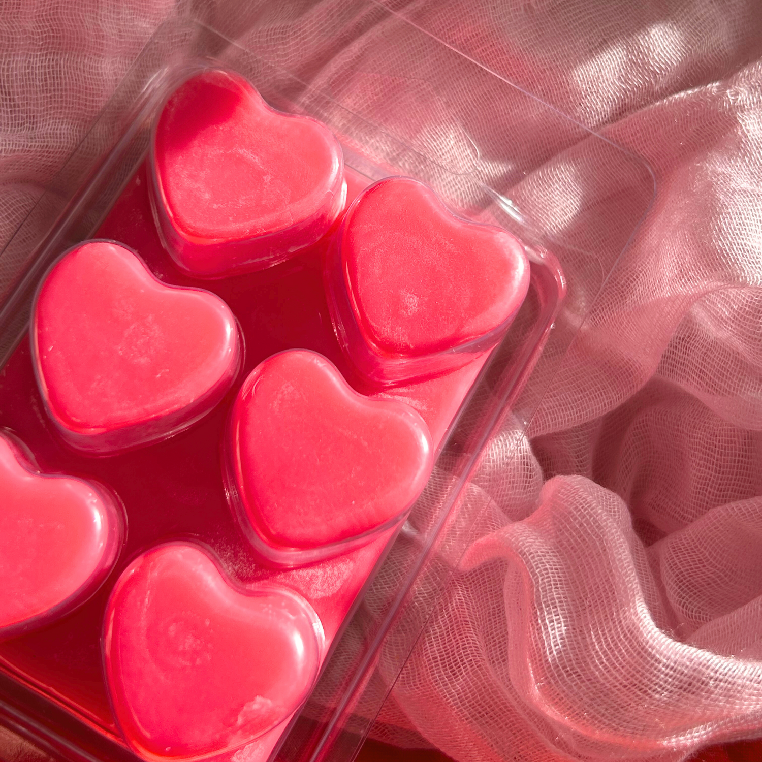 Back view of strawberry wax melts, showcasing the detailed heart-shaped design in a six-piece tablet for easy melting and fragrance release.