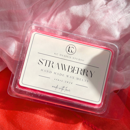 Front view of strawberry-scented wax melts in a tablet of six heart-shaped pieces, perfect for adding a sweet and fruity aroma to any space.