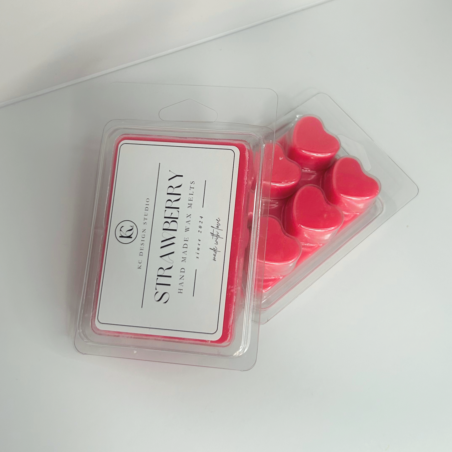 Stacked view of two packs of Strawberry Wax Melts, highlighting heart shapes and product label.