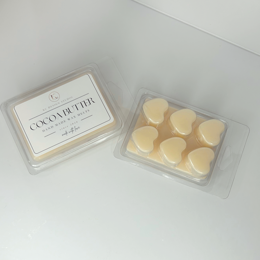 Top view of Cocoa Butter Cashmere wax melts displaying label and back side with heart-shaped plastic packaging