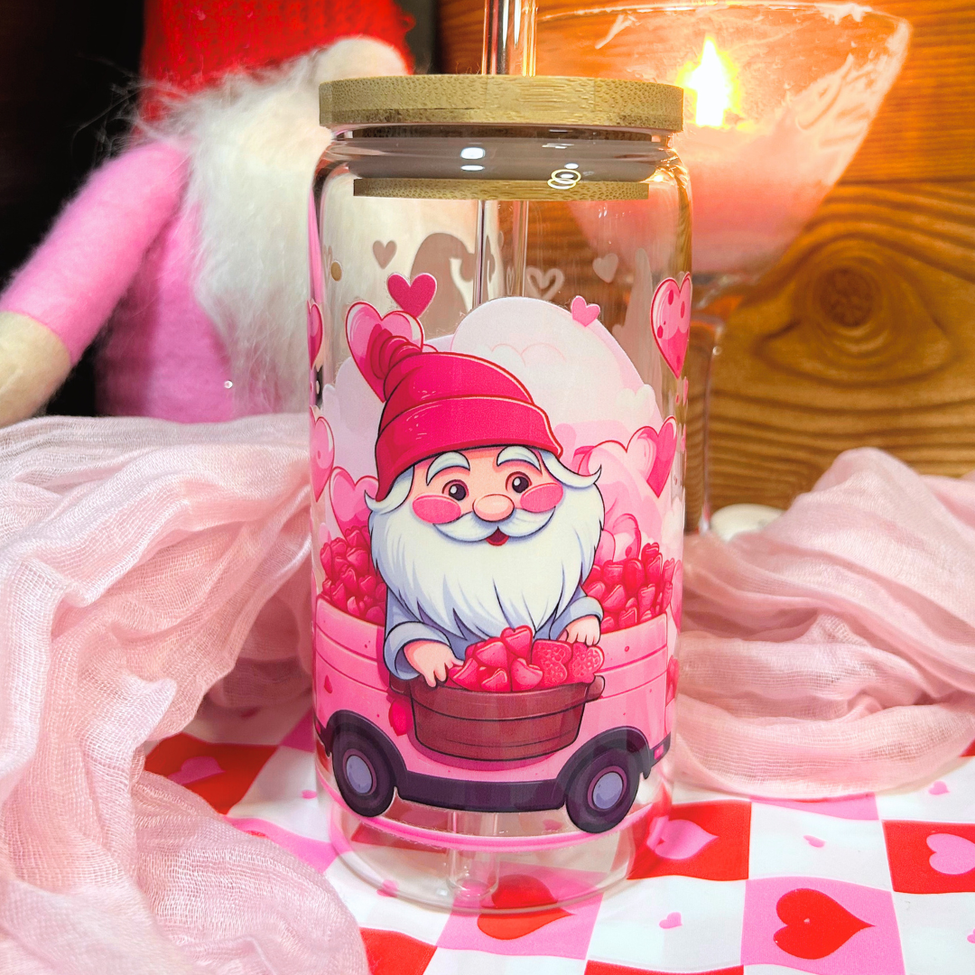 Glass tumbler with a Valentine's Day gnome design on a checkered tablecloth.
