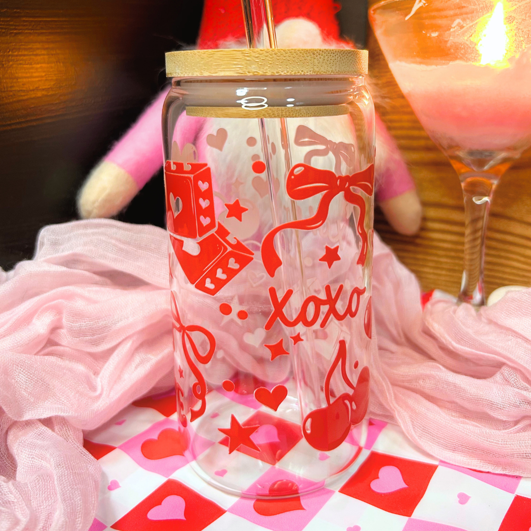 Clear tumbler with red graphics and 'XOXO' text on a checkered tablecloth.