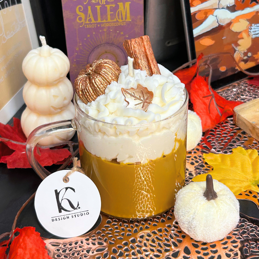 Vanilla Pumpkin Pie candle with whipped cream, cinnamon stick, and decorative pumpkins on a Halloween-themed table.