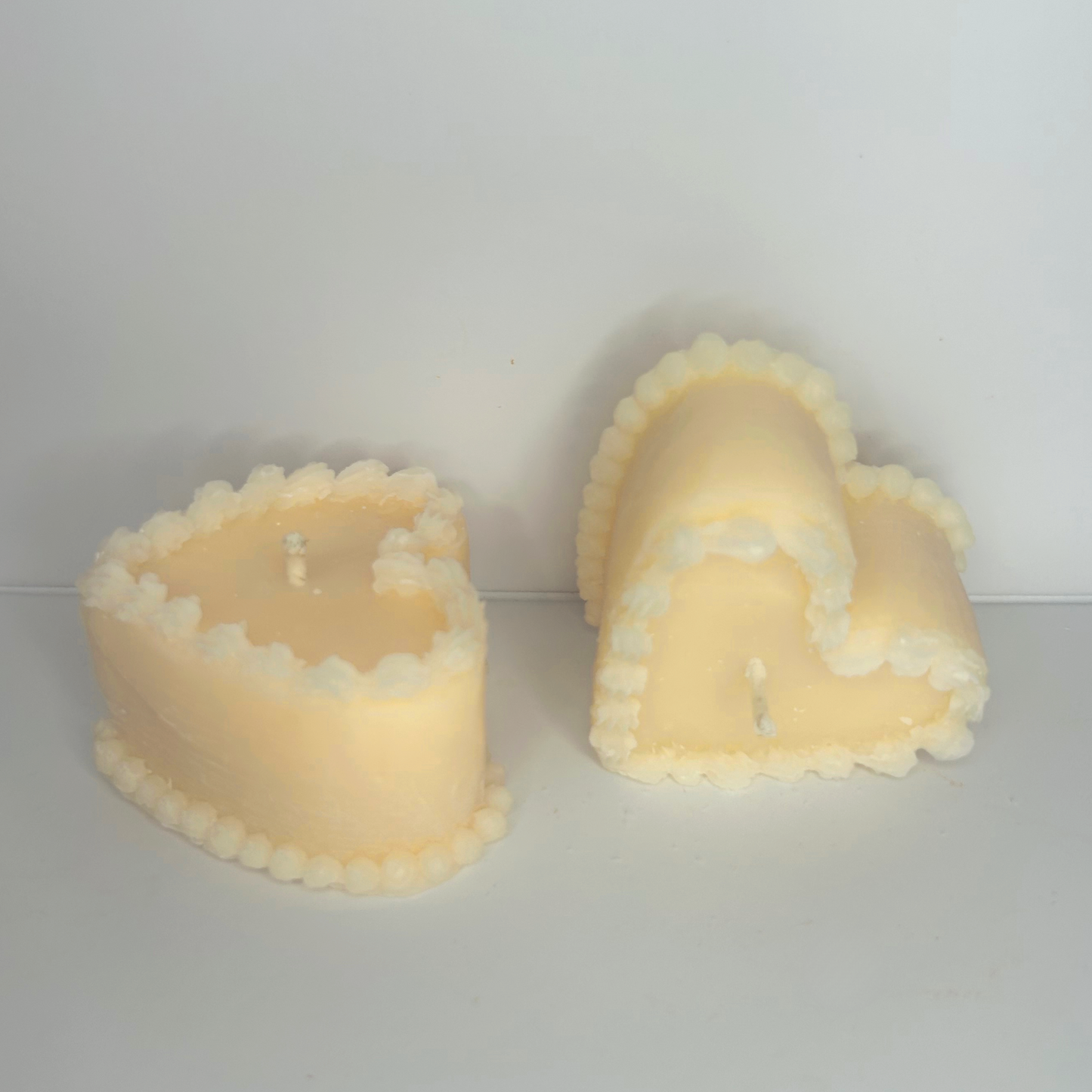 Front view of the two Decorative Vintage Heart-Shaped Cake Candles, highlighting their intricate details and inviting aroma.