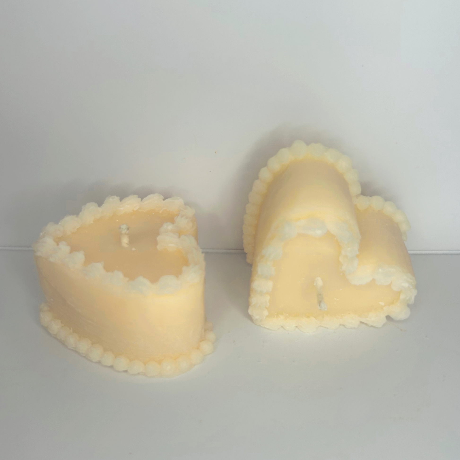 Front view of the two Decorative Vintage Heart-Shaped Cake Candles, highlighting their intricate details and inviting aroma.