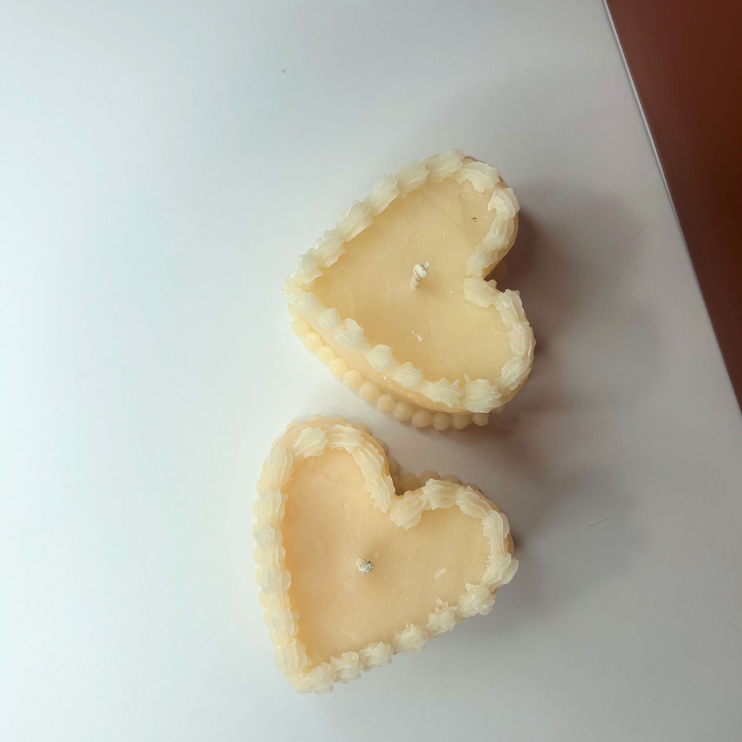 Top view of two Decorative Vintage Heart-Shaped Cake Candles, showcasing their vibrant colors and unique designs.