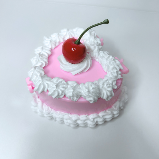 Top view of the Whimsical Vintage Heart-Shaped Jewelry Box with a cherry centerpiece and cream swirl details
