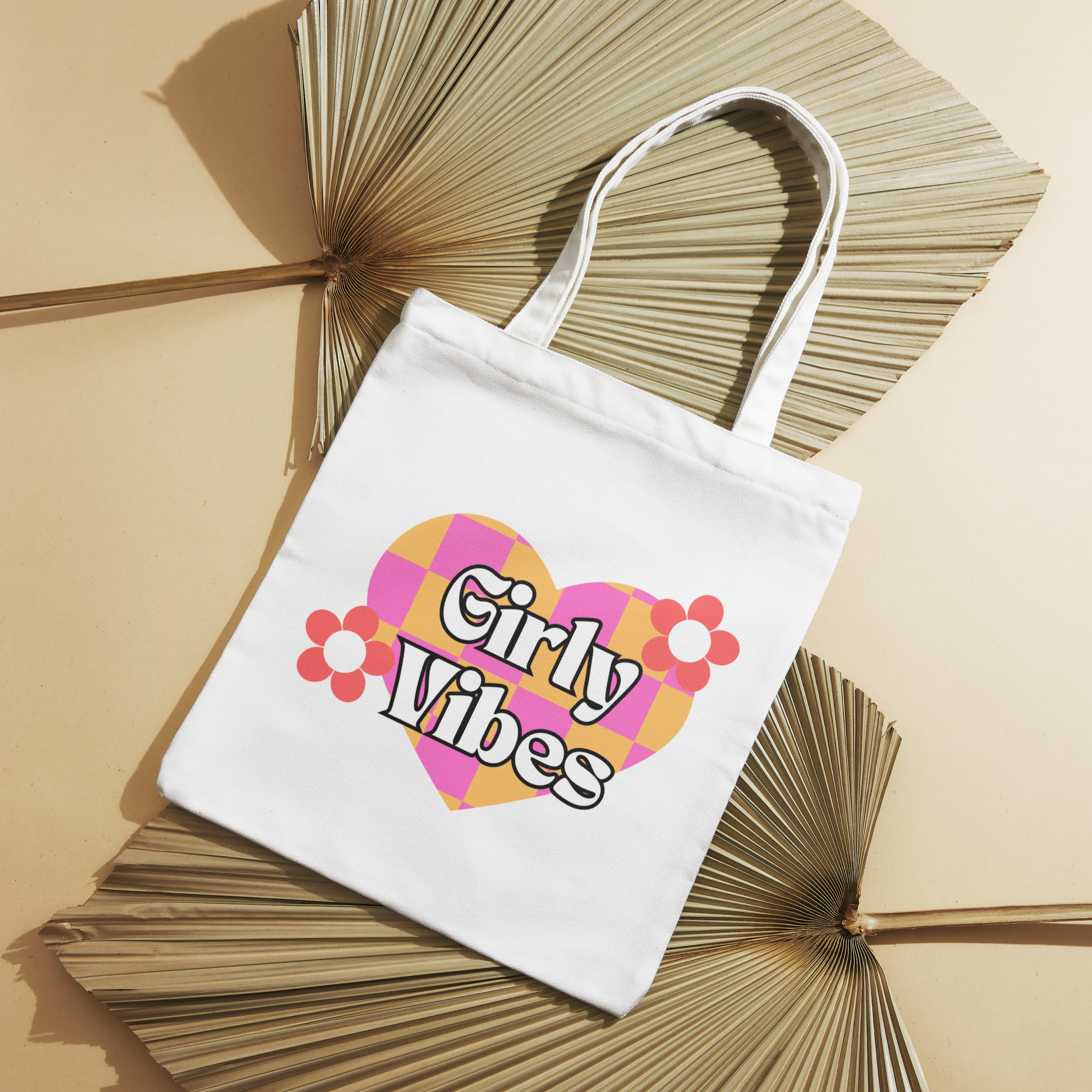 White canvas tote bag featuring a colorful heart with pink flowers and "Girly Vibes" text. Perfect for everyday use and durable for heavy loads.