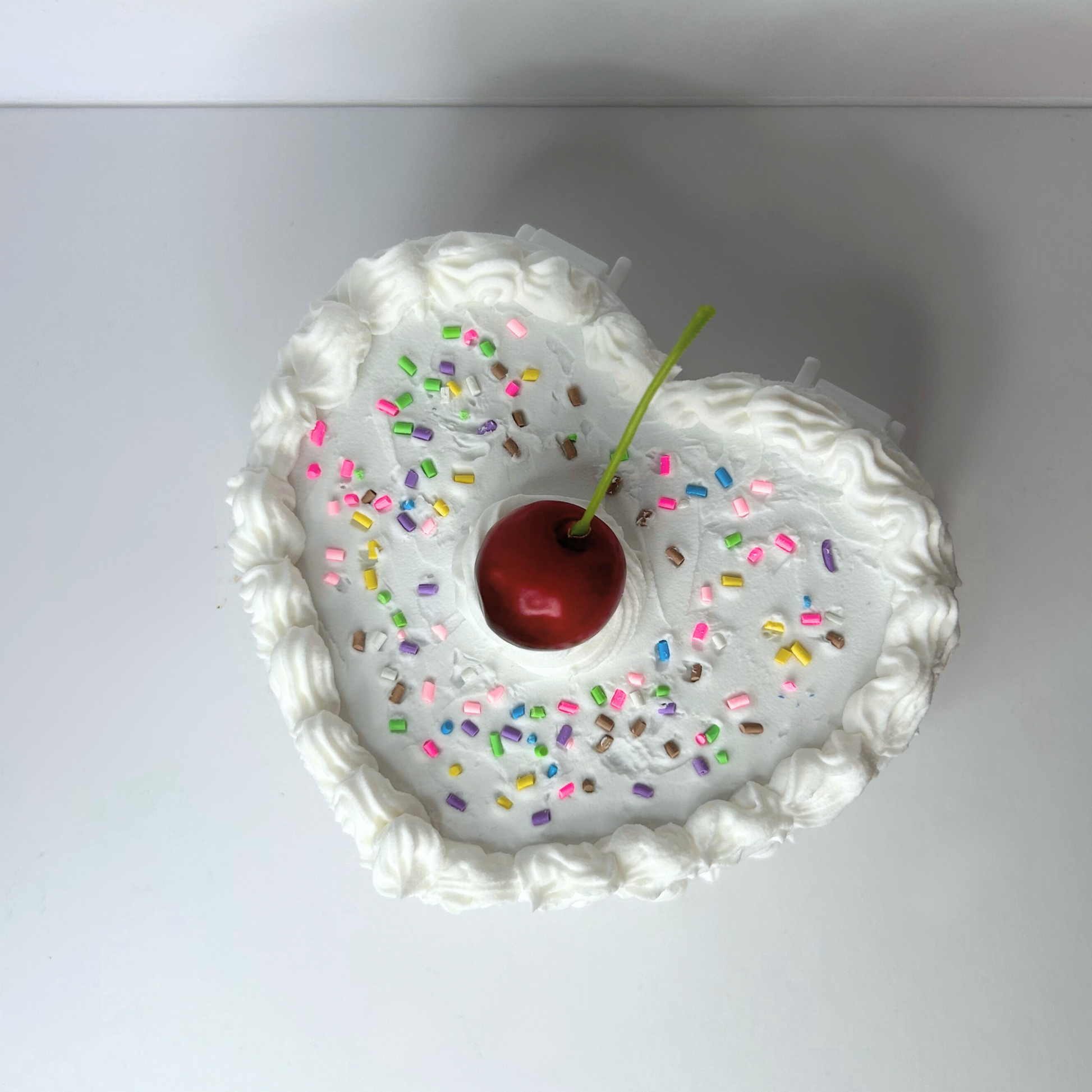 Top view of the White Cherry Heart Cake Vintage Jewelry Box, featuring a vibrant red cherry, colorful sprinkles, and a heart-shaped design evoking sweet vanilla cake.